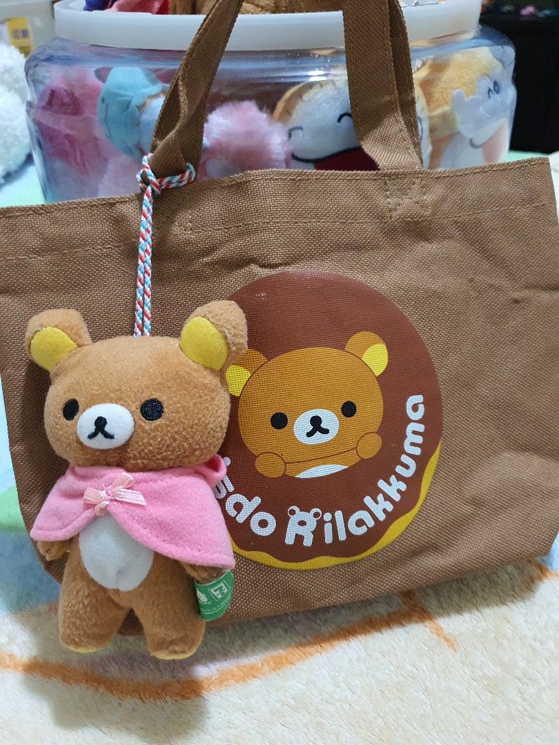 Misdo Rilakkuma 7-Eleven Tote Bag with Plush (Category: Plushies & Soft Toys) located in Quezon City. Submitted by peachhalves (Listing ID 1469583533, Image 1). Description: BUNDLE] Authentic San-X Rilakkuma x Mister Donut Tote Bag & Pink Cape Plush Charm • Japan Surplus / Preloved (Please refer to the photo for the actual condition of the items). • Colors are still vibrant, and the plush material is soft and intact Bag Interior (Flaw): The inner