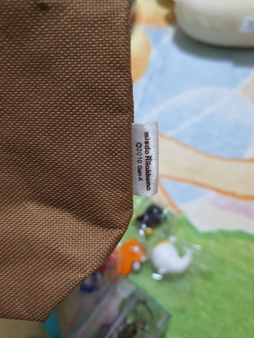 Misdo Rilakkuma 7-Eleven Tote Bag with Plush (Category: Plushies & Soft Toys) located in Quezon City. Submitted by peachhalves (Listing ID 1469583533, Image 3). Description: BUNDLE] Authentic San-X Rilakkuma x Mister Donut Tote Bag & Pink Cape Plush Charm • Japan Surplus / Preloved (Please refer to the photo for the actual condition of the items). • Colors are still vibrant, and the plush material is soft and intact Bag Interior (Flaw): The inner