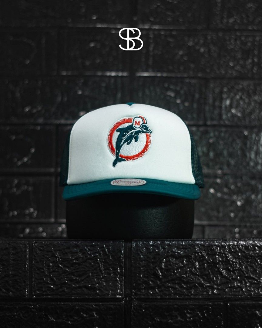 Mitchell & Ness Miami Dolphins Trucker Snapback Hat (Category: Caps & Hats) located in Manila. Submitted by dom032386 (Listing ID 1469585930, Image 1). Description: - Style: Trucker hat - Team: Miami Dolphins - Color: White and teal - Back: Classic breathable mesh - Closure: Adjustable snapback for easy sizing - Condition: Clean, ready to wear.