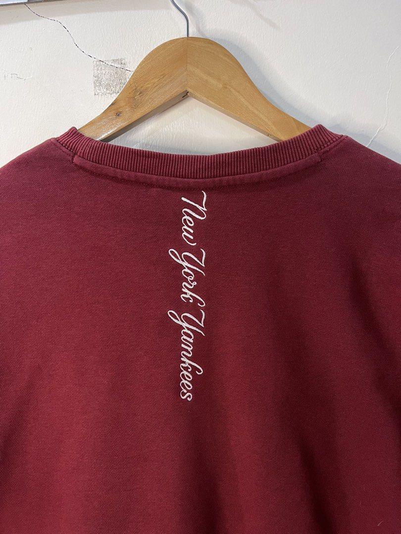 MLB New York Yankees Maroon Sweatshirt (Category: Coats, Jackets and Outerwear) located in Cabagan. Submitted by blessingma81004 (Listing ID 1469740284, Image 3). Description: - Item: Maroon MLB New York Yankees Sweatshirt - Design: Embroidered NY logo on chest, bold Yankees 1927 sleeve graphic, and vertical Yankees text embroidered on back collar - Size: Tagged S, fits M to L nicely - Measurements: Width 22 inches x Length 26.5 inches.