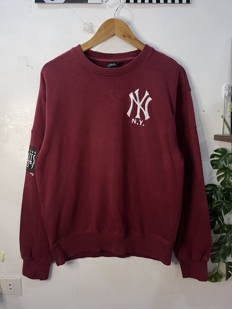 MLB New York Yankees Maroon Sweatshirt (Category: Coats, Jackets and Outerwear) located in Cabagan. Submitted by blessingma81004 (Listing ID 1469740284, Image 2). Description: - Item: Maroon MLB New York Yankees Sweatshirt - Design: Embroidered NY logo on chest, bold Yankees 1927 sleeve graphic, and vertical Yankees text embroidered on back collar - Size: Tagged S, fits M to L nicely - Measurements: Width 22 inches x Length 26.5 inches.