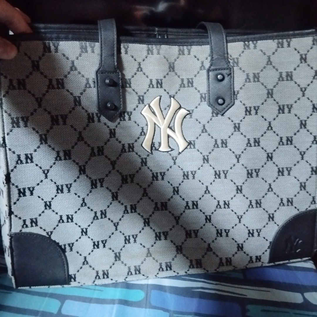 MLB New York Yankees Monogram Tote Bag (Category: Tote Bags) located in Manila. Submitted by lene48 (Listing ID 1469593854, Image 2). Description: -MLB New York Yankees tote bag - Stylish grey and black all-over monogram print with bold raised NY front logo - Durable black faux leather top handles and reinforced corner patches - Roomy and structured interior, perfect for daily use - Includes official MLB branding and authentication tag (2021).