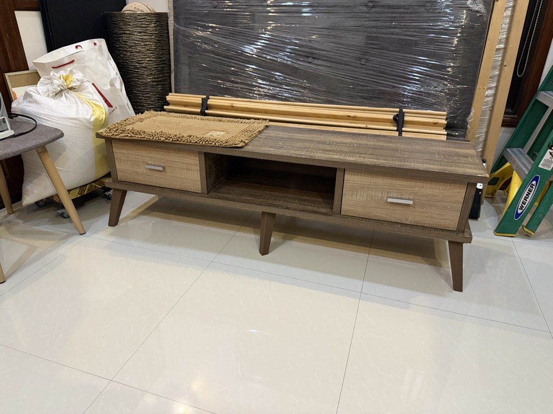 Modern Wood TV Console Media Unit 1.5m (Category: TV Consoles) located in Las Pinas. Submitted by shop.eo.home (Listing ID 1469608012, Image 2). Description: - Type: Wooden TV console - Dimensions: ~1.5m (L) x 40cm (W) x 45cm (H) - Storage: 2 sliding drawers with lighter wood grain fronts and silver handles, plus an open middle shelf - Design: Rustic brown finish supported by sturdy angled legs - Condition: Good, ideal for most living rooms and e