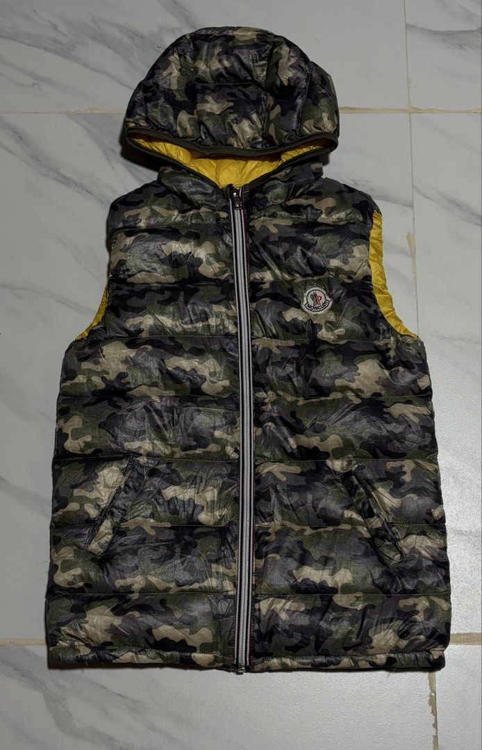Moncler Armoise Camouflage Down Puffer Vest (Category: Vests) located in Baguio. Submitted by thriftedbaguio (Listing ID 1469622846, Image 1). Description: Excellent Condition Size 4 Tagged Dimension 16*22 Color rate 10 .