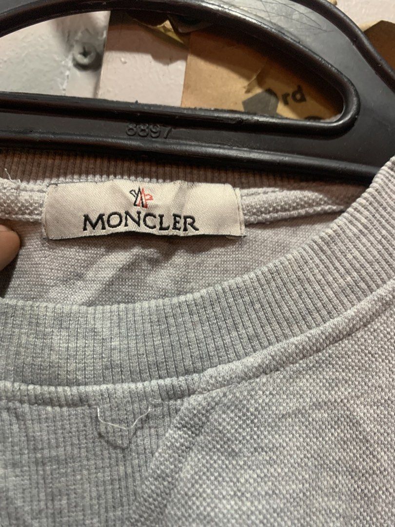 Moncler Grey Crewneck Sweatshirt (Category: Coats, Jackets and Outerwear) located in Cagayan de Oro. Submitted by agboysalis60090 (Listing ID 1469742823, Image 2). Description: Moncler grey long-sleeve sweatshirt. Crewneck design with small Moncler logo patch on the chest. 100 percent cotton material. Ribbed collar, cuffs, and hem. Made in China. Standard fit. Care tags and interior branding labels intact. Distressed design in Hem..
