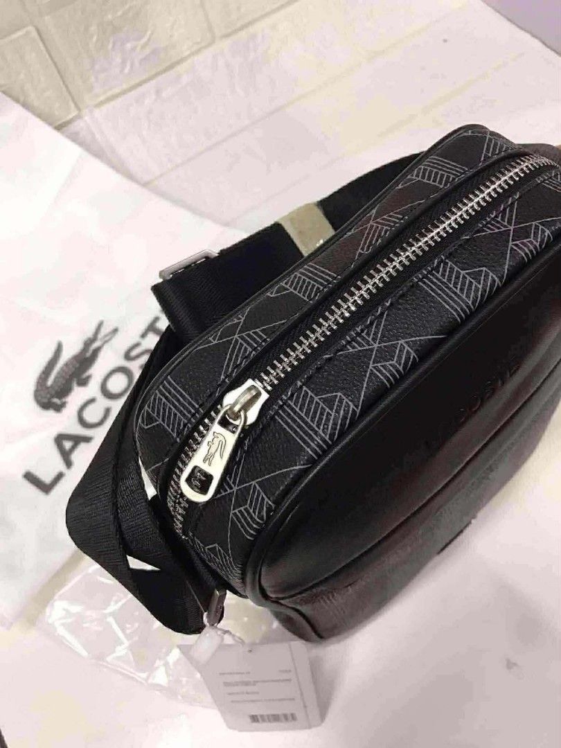 Monogram Print Crossbody Bag Black (Category: Sling Bags) located in Manila. Submitted by prime.dlor (Listing ID 1469743106, Image 3). Description: - Authentic Lacoste crossbody bag in black - Features a stylish geometric monogram pattern with smooth leather top panel - Silver-tone hardware with iconic embossed branding and tiny crocodile zipper pull - Adjustable black shoulder strap for comfortable wear - Includes original white dust bag and pap
