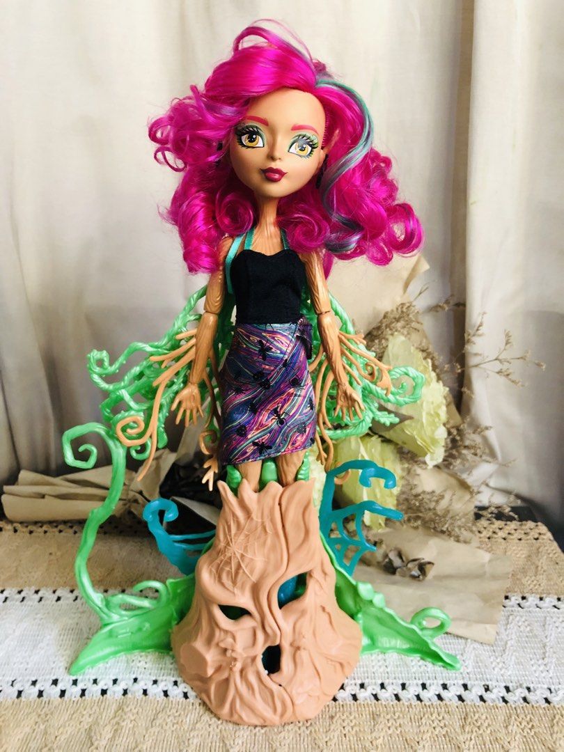 Monster High Garden Ghouls TREESA THORNWILLOW (Category: Kids Toys) located in Manila. Submitted by queen_princess.collections (Listing ID 1469581983, Image 2). Description: - Sold as is - Tight joints - 14.5-inch tree monster doll - Includes tree trunk playset base that transforms into a display stand - Bright pink and teal hair with unique woody textured limbs and tree-branch arm extensions - Detailed outfit featuring a stylish patterned skirt 