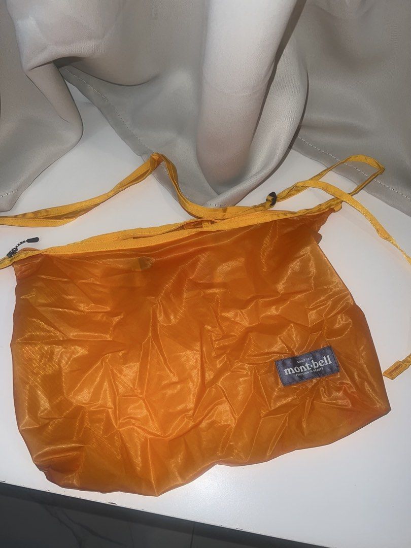 Mont-bell Orange Lightweight Nylon Bag (Category: Sling Bags) located in Paranaque City. Submitted by wednesday___ (Listing ID 1469591659, Image 2). Description: - Brand: Mont-bell - Color: Bright orange - Material: Ultra-lightweight ripstop nylon - Features: Secure top zipper closure, simple crossbody strap, branded patch detail - Portability: Packs down super small when not in use - Best for: Everyday errands and hiking trips.