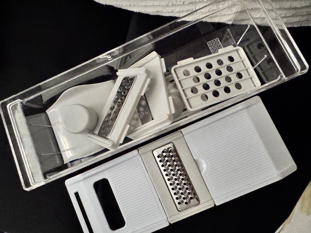 Multi-Function Kitchen Slicer Grater Set with Container (Category: Knives & Chopping Boards) located in Pasay City. Submitted by margucci_0823 (Listing ID 1469586191, Image 1). Description: - All-in-one kitchen tool for slicing, grating, and juicing - Includes clear storage container, main lid with grater insert, and citrus juicer attachment - Comes with multiple interchangeable blades for versatile meal prep - Compact design that saves cabinet s
