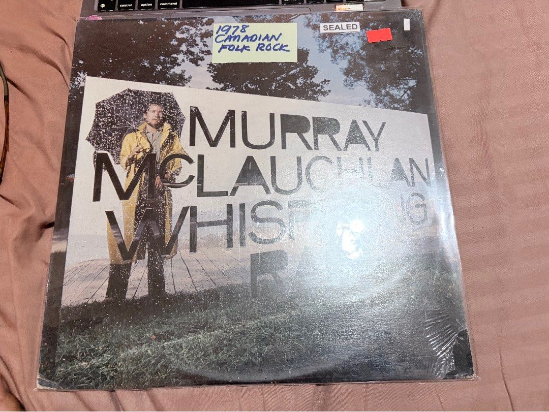 Murray McLauchlan Whispering Rain Vinyl Record LP (Category: Vinyls) located in Tabaco. Submitted by cinemahilig (Listing ID 1469579120, Image 1). Description: - Artist & Title: Murray McLauchlan - Whispering Rain - Release Year: 1978 - Genre: Canadian Folk Rock - Condition: Brand new, still sealed in original plastic wrapping - Cover Art: Clean with clear typography and grayscale photograph - Perfect addition to any classic vinyl collection.