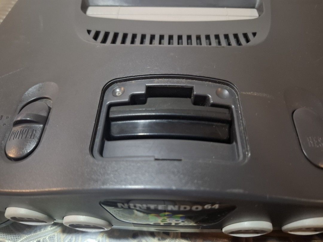 N64 set (Category: Nintendo) located in Antipolo. Submitted by lakay_toys (Listing ID 1469683835, Image 3). Description: Nintendo N64 black Japan set (Modified cartridge slot) Can play US and japanese games Bundle includes ►N64 unit ► 220 V power supply ►AV cable ►1 original n64 transparent controllers ►6 n64 cartridges ✨Supermario 64 ✨️ 007 goldeneye ✨️Pocket monster stadium ✨️ baseball ✨️ Super smash bros ✨ ️wave race ✅ good condition ✅ BUTTONS
