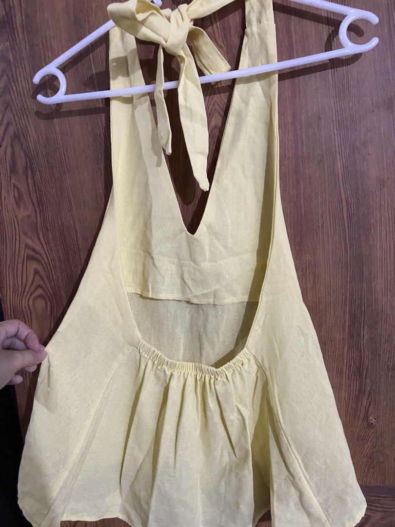 NA-KD Pastel Yellow Halter Top (Category: Sleeveless) located in Caloocan City. Submitted by lovedbyryu (Listing ID 1469684537, Image 3). Description: - Brand/Style: NA-KD halter neck top - Color: Pastel yellow - Details: Deep V-neckline, self-tie neck straps, open back with gathered elastic - Fit: Lightweight and flowy - Condition: Looks just like the stock photo - Perfect for: Warm weather outfits.