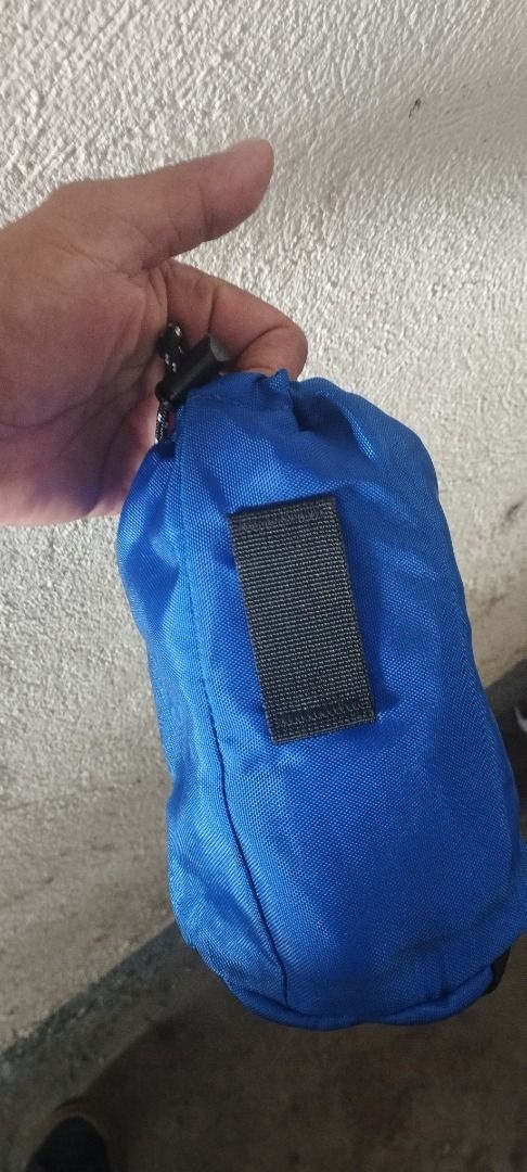 Nalgene 1.0L Bottle Pouch Blue (Category: Hiking & Camping) located in Koronadal. Submitted by jrdar (Listing ID 1469614435, Image 3). Description: - Color: Blue - Compatibility: Fits standard 1.0L Nalgene bottles - Closure: Drawstring with toggle lock at the top - Carrying/Attachment: Features webbing straps on the side and bottom - Material: Durable nylon - Condition: Clean, no tears or fraying.