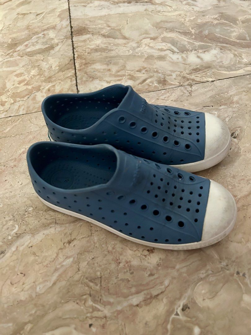Native Shoes Jefferson Child Size C13 Blue (Category: Babies & Kids Fashion) located in Quezon City. Submitted by poaimommy (Listing ID 1469581714, Image 2). Description: - Brand/Model: Native Jefferson Kids Slip-On Shoes - Color: Blue with white toe caps - Size: C13 (stamped on soles) - Material: Lightweight, perforated EVA for airflow and quick drying - Condition: Moderate tread wear and scuff marks on toe bumpers from normal use - Features: Ea