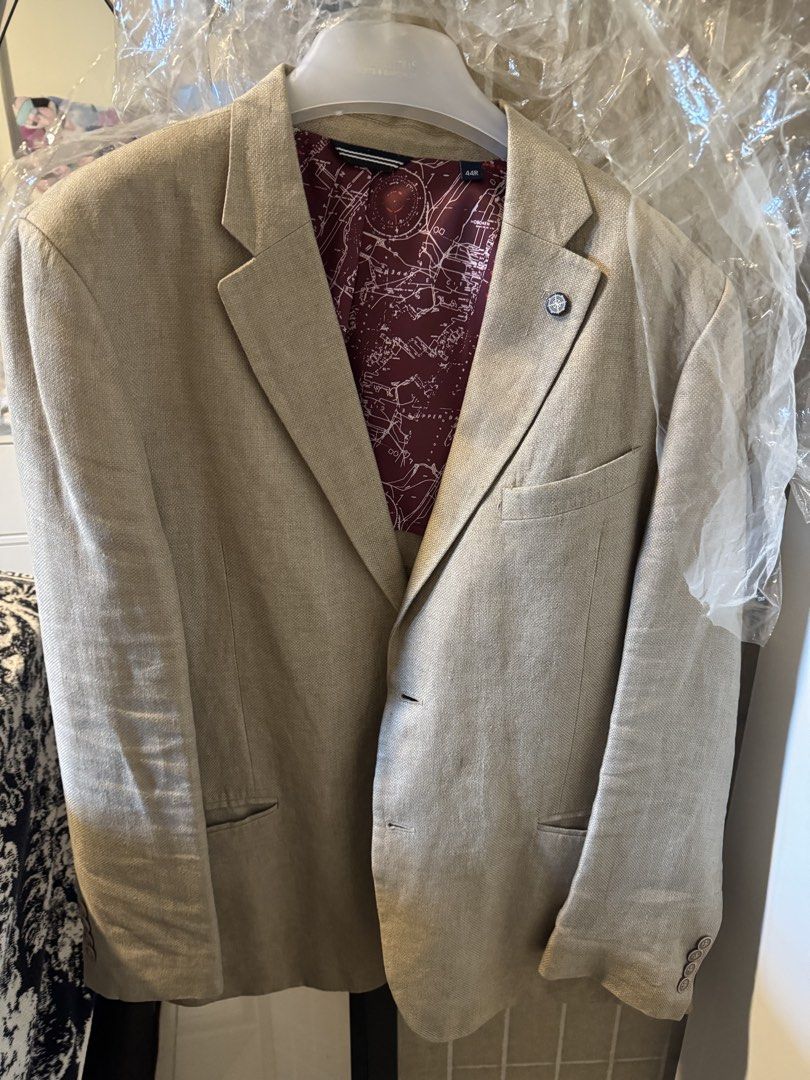 Nautica Beige Blazer Size 44R (Category: Coats, Jackets and Outerwear) located in Taguig. Submitted by dependingonvibe (Listing ID 1469620235, Image 1). Description: - Brand: Nautica - Color: Beige - Size: 44R (fits XL. American size) - Lining: Unique dark red map pattern - Features: Interior pockets and lapel pin - Condition: Clean and ready to wear - Versatility: Perfect for formal events or smart-casual outings Bought in USA. .