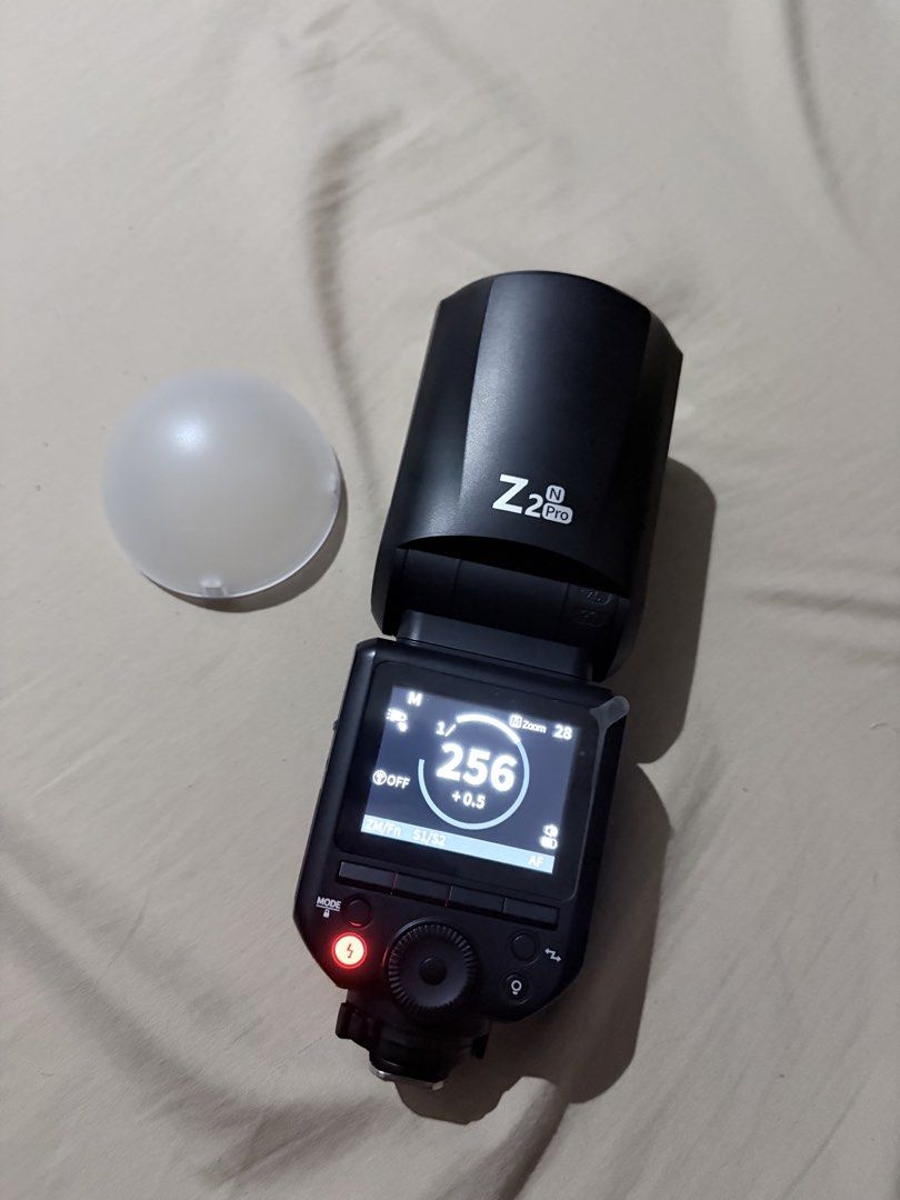 Neewer Z2 Pro Round Head Flash Speedlite Nikon (Category: Flashes) located in Quezon City. Submitted by angelajuliet__ (Listing ID 1469661432, Image 3). Description: - Brand/Model: Neewer Z2 Pro Round Head Flash Speedlite for Nikon - Condition: Fully functional, powers on cleanly with a bright, clear display - Power & Performance: 76Ws output power and 1/8000s High-Speed Sync (HSS) - Battery: Long-lasting 3000mAh rechargeable battery - Interface: