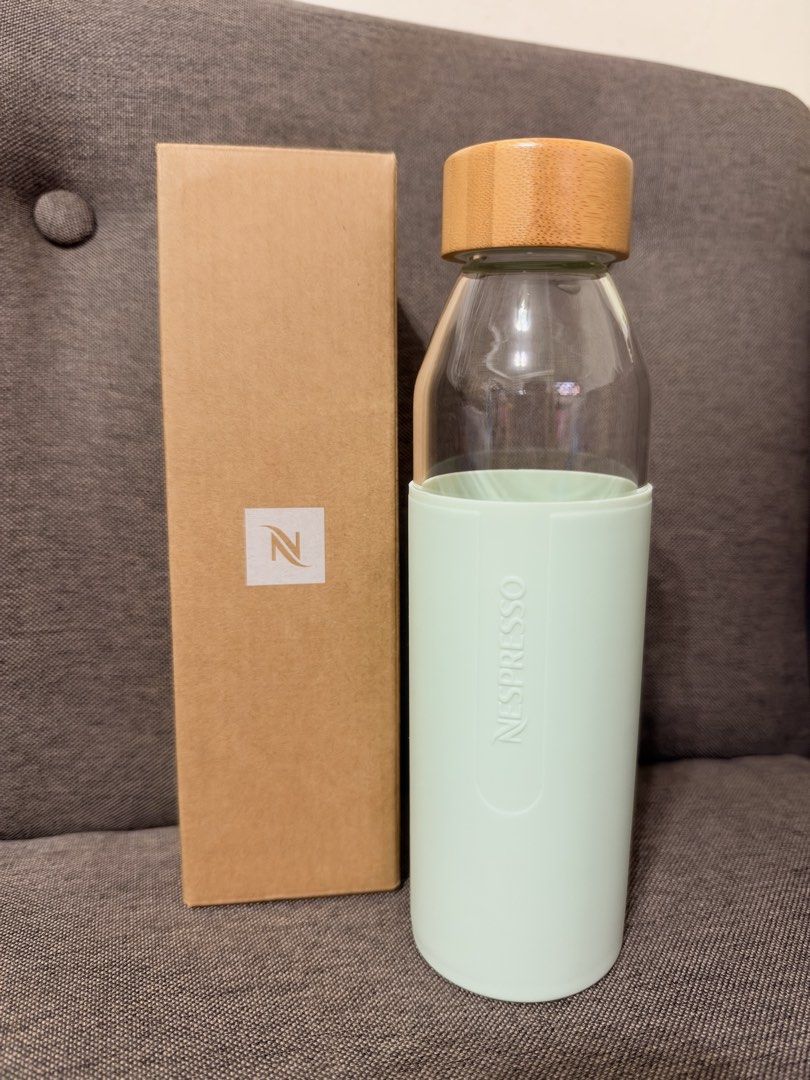 Nespresso Glass Water Bottle (Category: Water Bottles & Tumblers) located in Del Monte. Submitted by rigellerey51617 (Listing ID 1469726094, Image 1). Description: - Official Nespresso glass water bottle - Mint green silicone sleeve with embossed Nespresso logo - Secure wooden screw-on cap - Brand new, never used, and comes in original brown cardboard box - Perfect for office use or desk display.