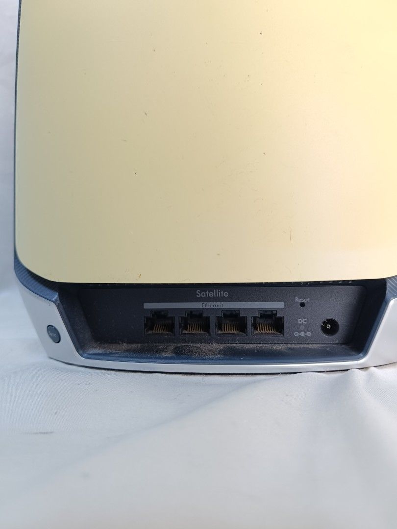 Netgear Orbi Satellite RBS850 (Category: Networking) located in Baguio. Submitted by clothes.over.bros.ph_2020 (Listing ID 1469596093, Image 2). Description: SOLD AS SET - Model: Netgear Orbi Satellite RBS850 - Color: White finish with a sleek silver base - Connectivity: 4 Gigabit ethernet ports on the back panel - Features: Standard power input port and physical reset button - Details: Serial number and MAC address intact on bottom label - Condi