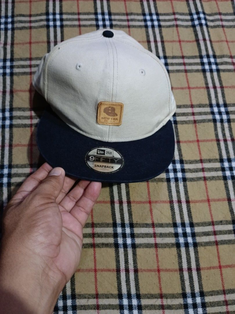 New Era 9FIFTY Snapback Cap Off-White Navy (Category: Caps & Hats) located in General Santos City (Dadiangas). Submitted by freehorse.5f2a61 (Listing ID 1469629096, Image 1). Description: - Brand: New Era 9FIFTY Snapback - Color: Off-white crown with navy visor - Design: Leather square patch with New Era logo and EST. 1920 text - Material: 100% cotton for maximum comfort - Size: One size fits most with an adjustable snapback closure - Details: In