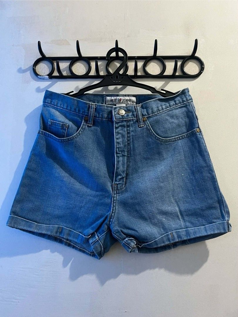 Next Jeans Denim Shorts cuffed medium wash (Category: Shorts) located in Manila. Submitted by vin_take (Listing ID 1469682363, Image 1). Description: - Brand: Next Jeans - Wash: Medium wash denim - Cut: High waist with button fly - Hem: Rolled cuffs - Details: Classic five-pocket setup, contrast stitching, and standard belt loops - Condition: Clean with no heavy fading.