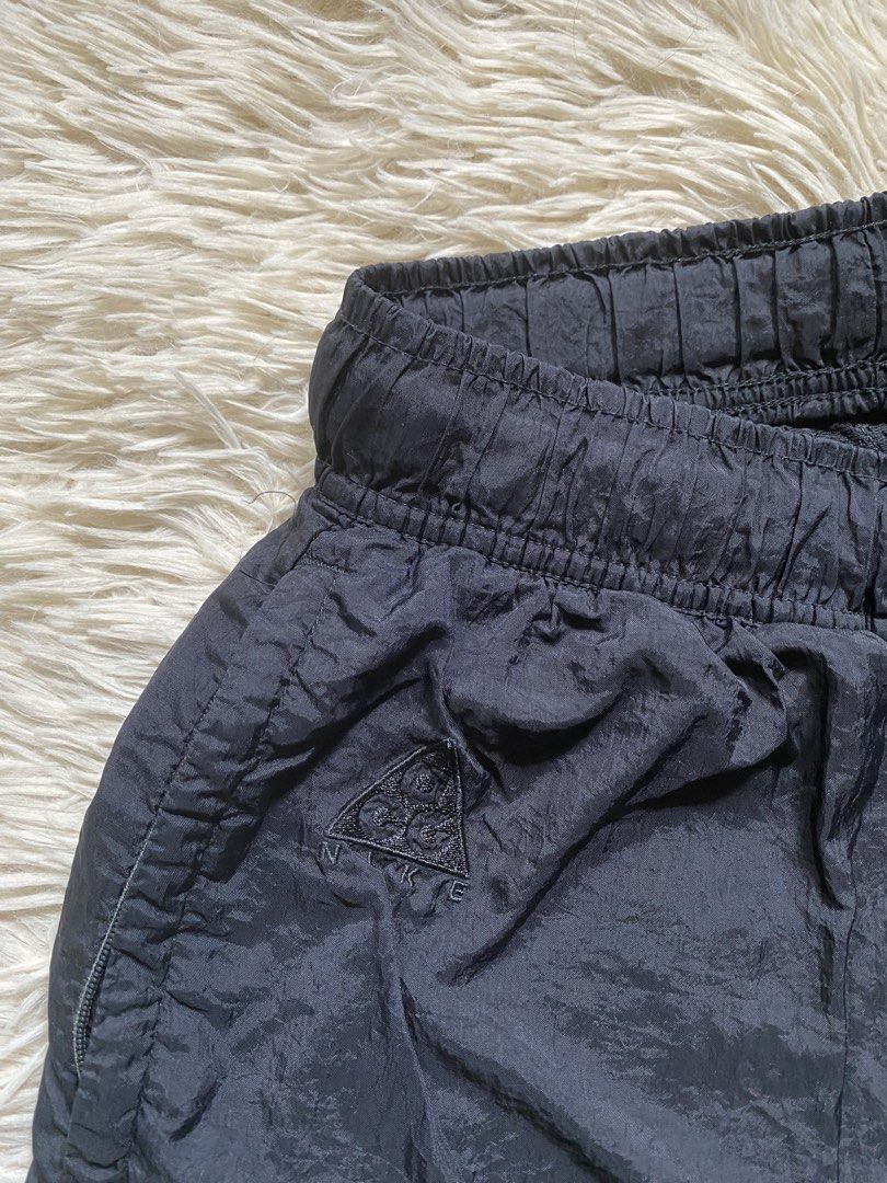 Nike ACG Black Nylon Shorts Size M (Category: Shorts) located in Antipolo. Submitted by switchneighborhood (Listing ID 1469652445, Image 2). Description: - Brand: Nike ACG - Color: Solid Black - Size: Medium (tag attached) - Material: Lightweight, durable nylon with breathable mesh lining - Waistband: Elastic with adjustable belt buckle for a secure fit - Pockets: Regular side pockets + secure zippered back pocket - Details: Embroidered ACG trian