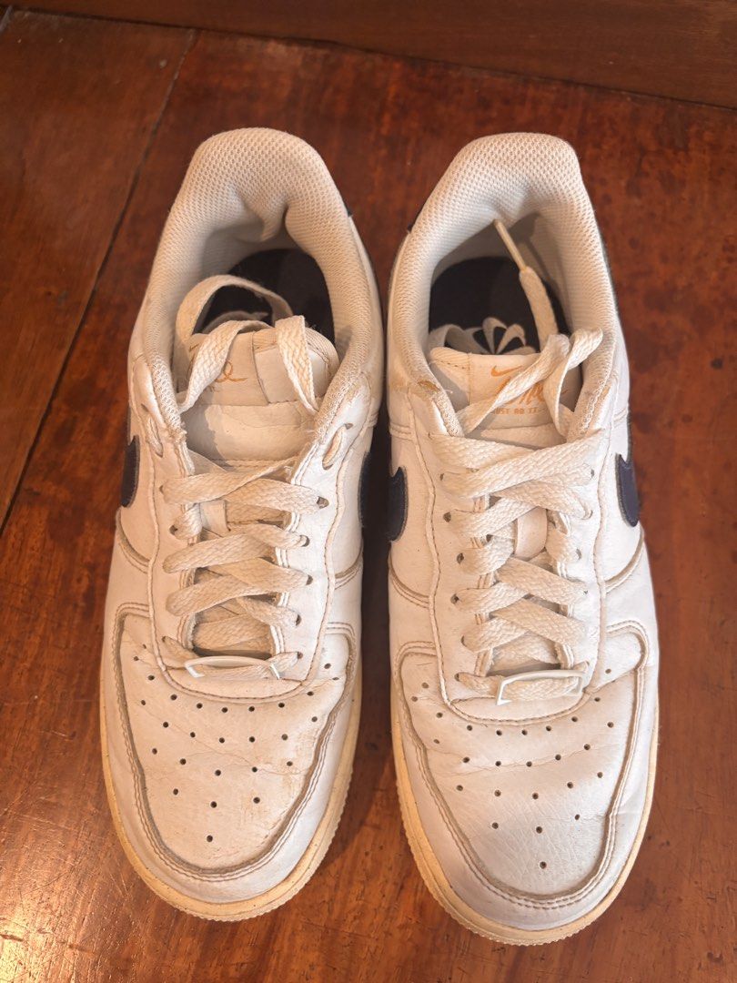 Nike Air Force 1 White Navy (Category: Sneakers) located in Quezon City. Submitted by ivifrancis70303 (Listing ID 1469613325, Image 3). Description: - Style: Classic Nike Air Force 1 Low - Colorway: White leather with navy blue swooshes - Condition: Pre-owned with a vintage aesthetic - Details: Yellowed midsoles, toe box creasing, and regular outsole wear - Inclusions: Comes with original laces - Perfect for daily casual wear and streetwear fits.