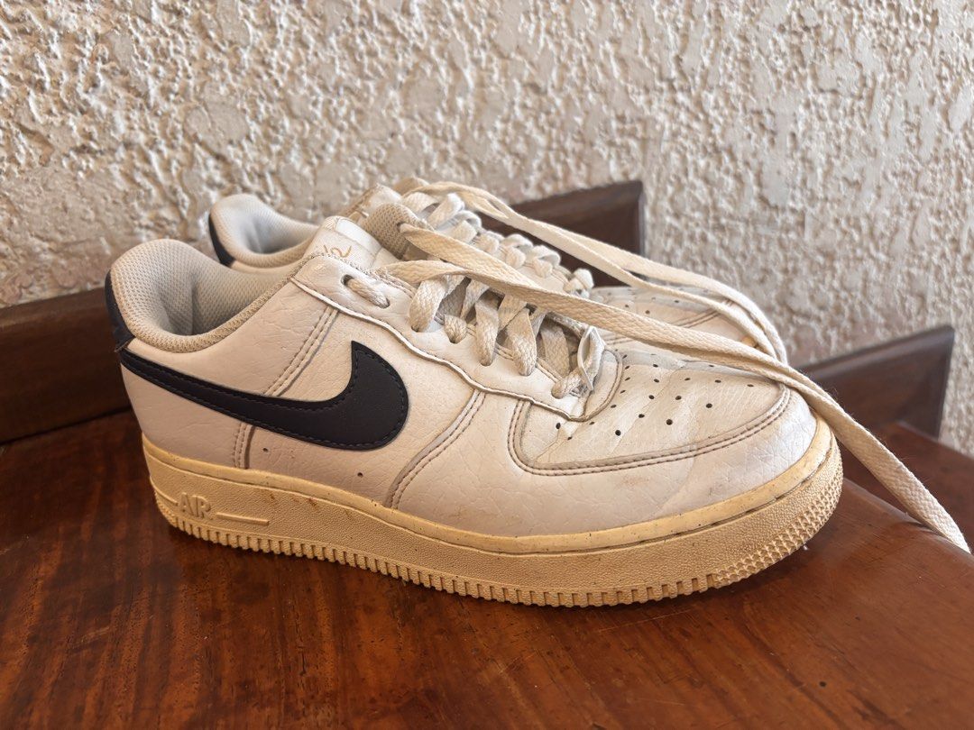 Nike Air Force 1 White Navy (Category: Sneakers) located in Quezon City. Submitted by ivifrancis70303 (Listing ID 1469613325, Image 2). Description: - Style: Classic Nike Air Force 1 Low - Colorway: White leather with navy blue swooshes - Condition: Pre-owned with a vintage aesthetic - Details: Yellowed midsoles, toe box creasing, and regular outsole wear - Inclusions: Comes with original laces - Perfect for daily casual wear and streetwear fits.