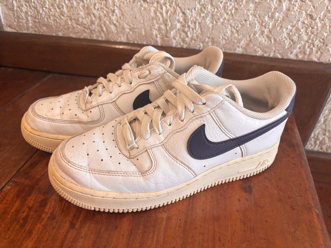 Nike Air Force 1 White Navy (Category: Sneakers) located in Quezon City. Submitted by ivifrancis70303 (Listing ID 1469613325, Image 1). Description: - Style: Classic Nike Air Force 1 Low - Colorway: White leather with navy blue swooshes - Condition: Pre-owned with a vintage aesthetic - Details: Yellowed midsoles, toe box creasing, and regular outsole wear - Inclusions: Comes with original laces - Perfect for daily casual wear and streetwear fits.
