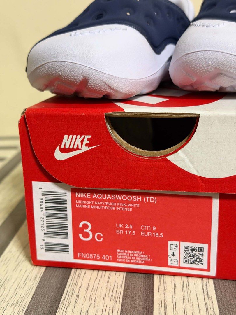 Nike Aquaswoosh Toddler (Category: Babies & Kids Fashion) located in Manila. Submitted by bizfits_ (Listing ID 1469618292, Image 2). Description: - Brand: Nike Aquaswoosh Toddler Sandals - Colorway: Midnight Navy, Rush Pink, and White - Size: US 3C / UK 2.5 / EUR 18.5 / 9 CM / BR 17.5 - Design: Easy slip-on with ventilation holes for breathability and a back strap for a secure fit - Details: Cute pink Nike swoosh logo on the side - Packaging: Ori