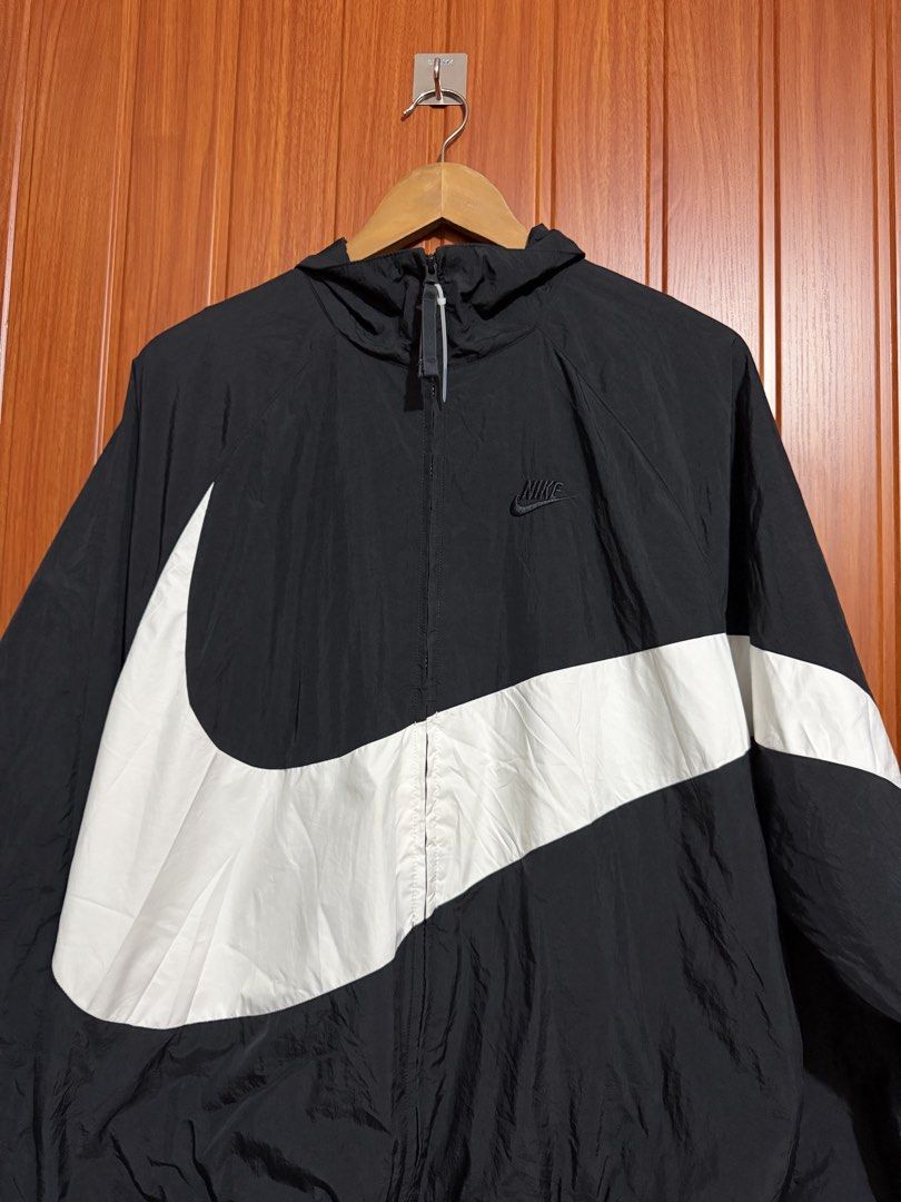 Nike Big Swoosh Black White Windbreaker Jacket (Category: Coats, Jackets and Outerwear) located in Manila. Submitted by tlfph (Listing ID 1469690742, Image 2). Description: - Brand: Nike - Item: Black and White Windbreaker Jacket - Size: Medium - Design: Iconic huge wrap-around Swoosh logo on chest and back - Material: Lightweight outer with breathable mesh inner lining - Features: Zip-up front, attached hood, elastic cuffs and hem - Origin: Made