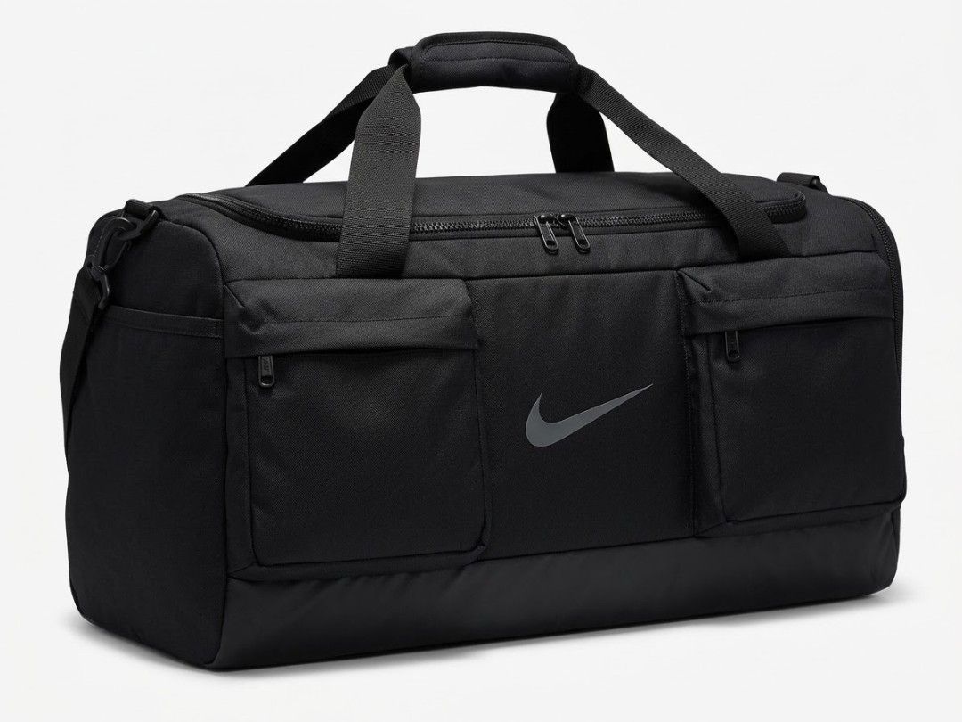 Nike Black Gym Duffel Bag. (Authentic) (Category: Backpacks) located in Manila. Submitted by fiercehorse-60ca (Listing ID 1469623083, Image 1). Description: - Color: Sleek black with grey Nike swoosh logo - Storage: Sprawling main compartment with twin zip pulls and two large front zippered pockets - Durability: Tough coated bottom panel for extra wear resistance - Versatility: Dual top carry handles and side D-ring for a shoulder strap (strap no