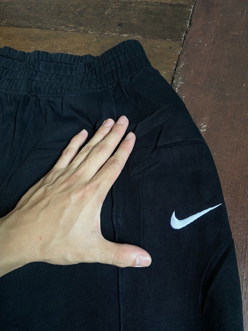 Nike Black Joggers Sweatpants Medium (Category: Joggers) located in Manila. Submitted by mavcl (Listing ID 1469697762, Image 3). Description: - Brand: Nike - Item: Fleece Joggers / Sweatpants - Color: Black with white embroidered Swoosh logo - Size: Medium (Standard fit) - Material: 80% cotton, 20% polyester body; 100% cotton pocket bags - Design: Elastic waistband, matching ankle cuffs, and center seam detailing on legs - Origin: Made in Pakista