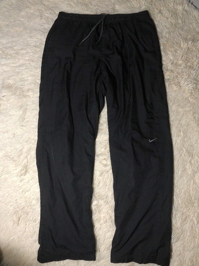 Nike Black Nylon Track Pants 2XL (Category: Joggers) located in Maria Aurora. Submitted by kylerikathriftshop101010 (Listing ID 1469711676, Image 1). Description: freewaist 41 length 8.7 hem see pics issues:repairs di halata masyadon - Brand: Nike - Color: Black - Size: 2XL (Made in Korea) - Material: Lightweight nylon - Features: Elastic drawstring waistband, embroidered Nike swoosh near the knee - Condition: Pre-owned with minor surface snags a