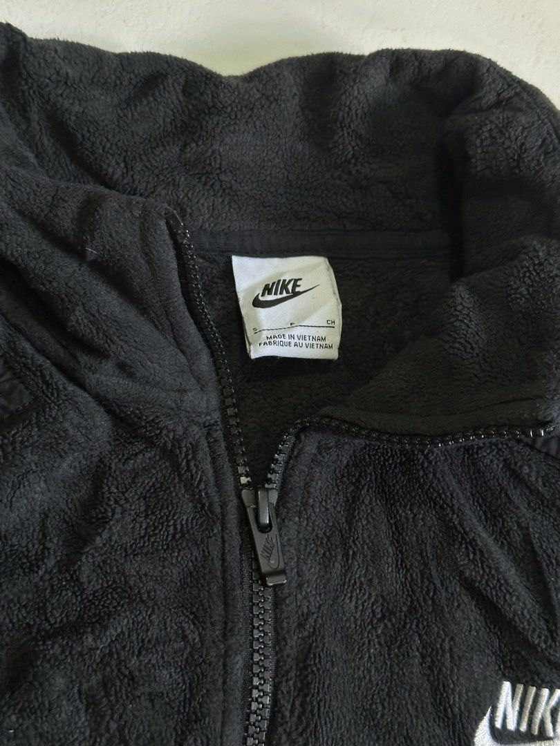 Nike Black Sherpa Fleece 1/4 Zip Pullover (Category: Coats, Jackets and Outerwear) located in Cavite. Submitted by remcadzzz (Listing ID 1469609908, Image 3). Description: - Brand: Nike - Style: Sherpa Fleece Half-Zip Sweatshirt - Style Code: DD4870-010 - Color: Black with white embroidered chest logo - Size: Small on tag but best fit M to Semi Large - Origin: Made in Vietnam - Features: Front kangaroo pocket, super cozy and warm material ideal f