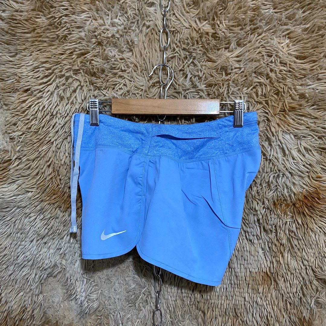 Nike Blue Running Shorts with Zip Pocket (Category: Shorts) located in Butuan. Submitted by jc13thrifts (Listing ID 1469752349, Image 2). Description: - Brand: Nike - Color: Light blue with white Swoosh logo - Waistband: Contrast textured design with drawstring closure - Storage: Convenient zipped pocket at the back - Ideal for: Running, workouts, or casual active wear.