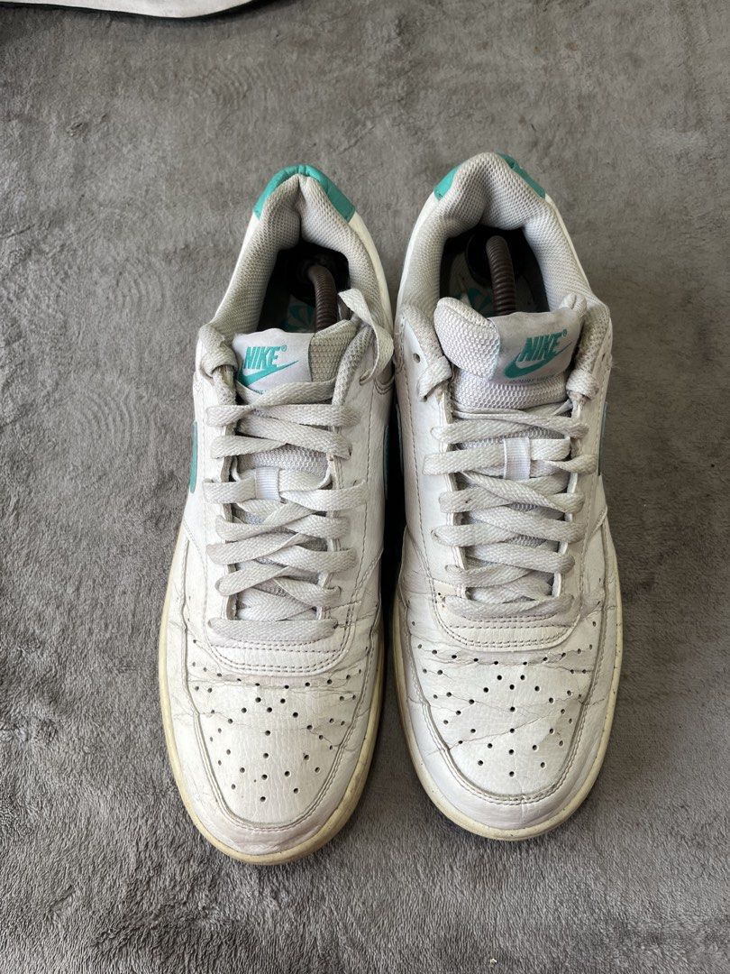 Nike Court Vision Low | Size 44 (Category: Sneakers) located in General Trias. Submitted by zrchustle.604 (Listing ID 1469756600, Image 2). Description: Nike Court Vision Low, featuring a white synthetic leather upper accented by a distinct teal Swoosh logo and heel tab. This classic design takes visual styling inspiration from 1980s retro basketball footwear and features structured stitching, a perforated toe box, and a durable rubber outsole..