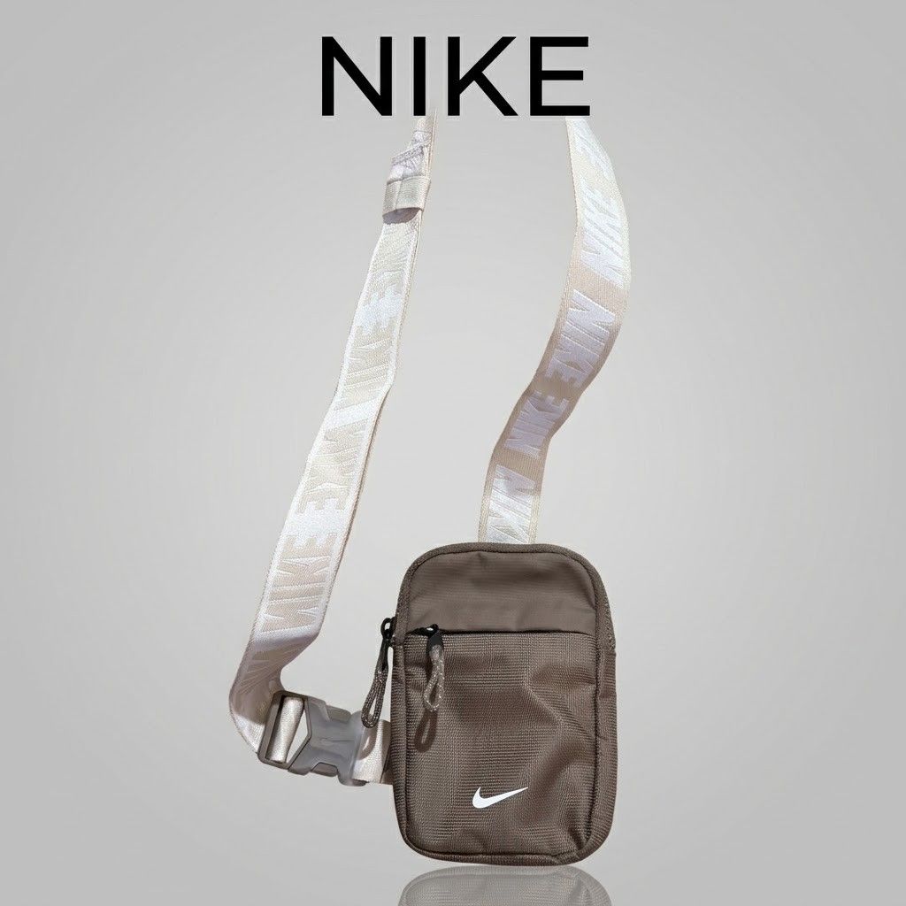 Nike Crossbody Bag Brown (Category: Belt bags, Clutches and Pouches) located in Carmen. Submitted by ar_thrift00 (Listing ID 1469635136, Image 1). Description: - Brand: Nike - Color: Brown with adjustable white logo strap - Material: Durable canvas - Storage: Main compartment with mesh inner pocket + front zippered pocket - Closure: Quick-release buckle - Condition: Clean inside and out, ready to use - Perfect for: Carrying daily essentials, phon