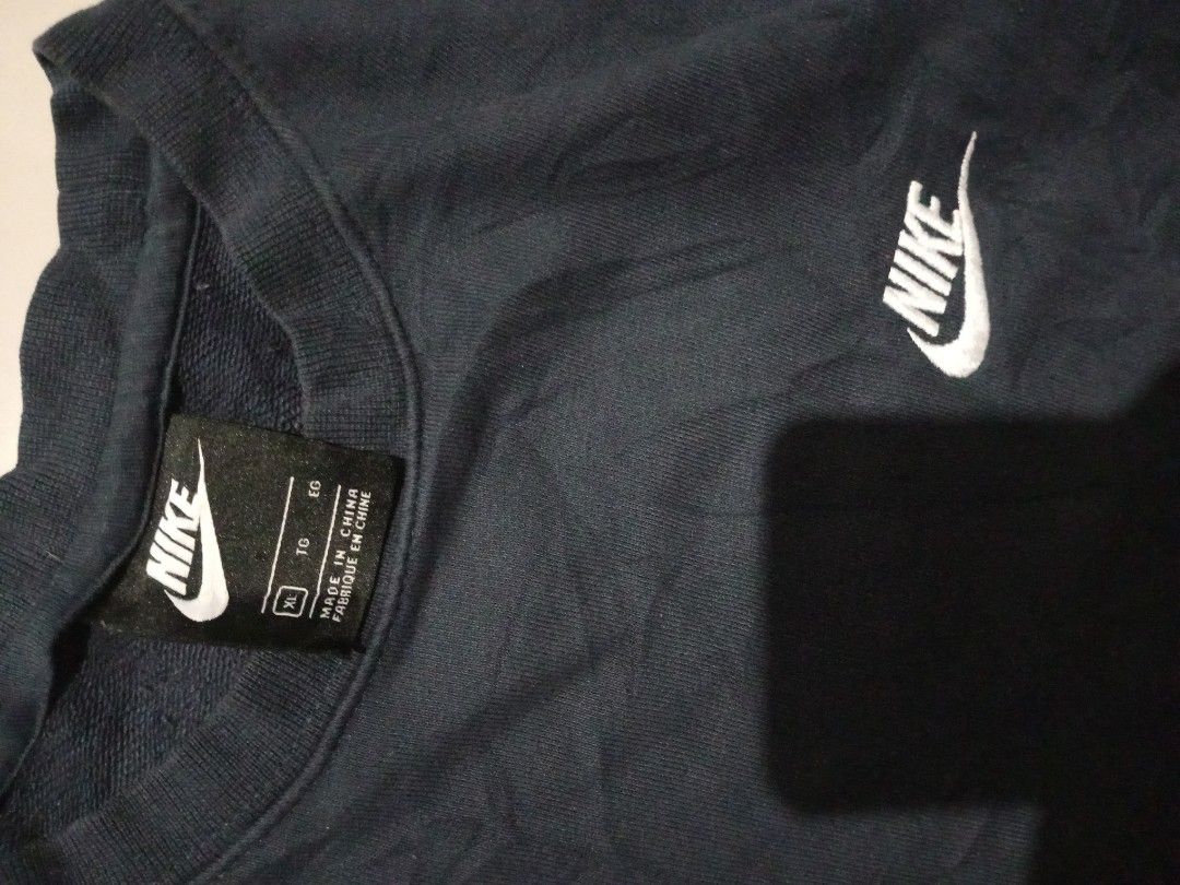 Nike Dark Blue Sweatshirt Size XL (Category: Coats, Jackets and Outerwear) located in Bacolod City. Submitted by richjohn.958 (Listing ID 1469664538, Image 2). Description: - Brand: Nike - Color: Dark Blue - Size: XL - Style: Classic crewneck with small embroidered swoosh logo - Material: Comfortable fleece lining inside - Details: Ribbed collar, cuffs, and hem; made in China - Condition: Clean overall, great for cooler days.
