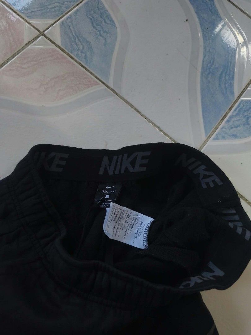 Nike Dri-FIT Black Jogger (Category: Joggers) located in Manila. Submitted by cookthrift (Listing ID 1469573966, Image 3). Description: - Authentic Nike joggers in sleek black - Dri-FIT technology keeps you cool and dry - Size: Small to medium - Branded elastic waistband with adjustable inner drawstring - Classic grey Nike swoosh on the left leg - Comfortable cuffed hems at the bottom - Smooth, lightweight fabric ideal for workouts or everyday lo