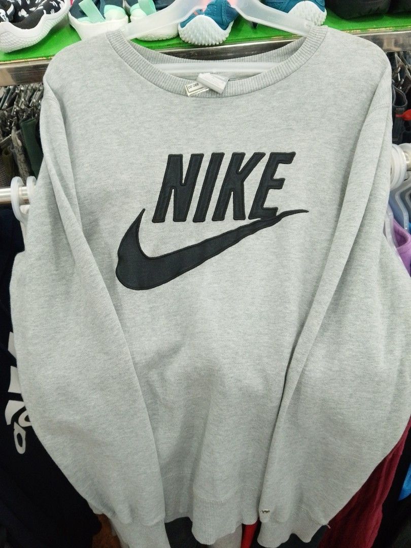 Nike Grey Sweatshirt with Black Logo (Category: Coats, Jackets and Outerwear) located in Manila. Submitted by afreemf (Listing ID 1469643019, Image 1). Description: - Authentic grey Nike sweatshirt with a bold black embroidered logo across the chest - Classic crewneck design with durable ribbed cuffs and hem - Soft and warm fleece lining for all-day comfort - Versatile casual staple, perfect for everyday wear or layering - Condition: Excellent / 