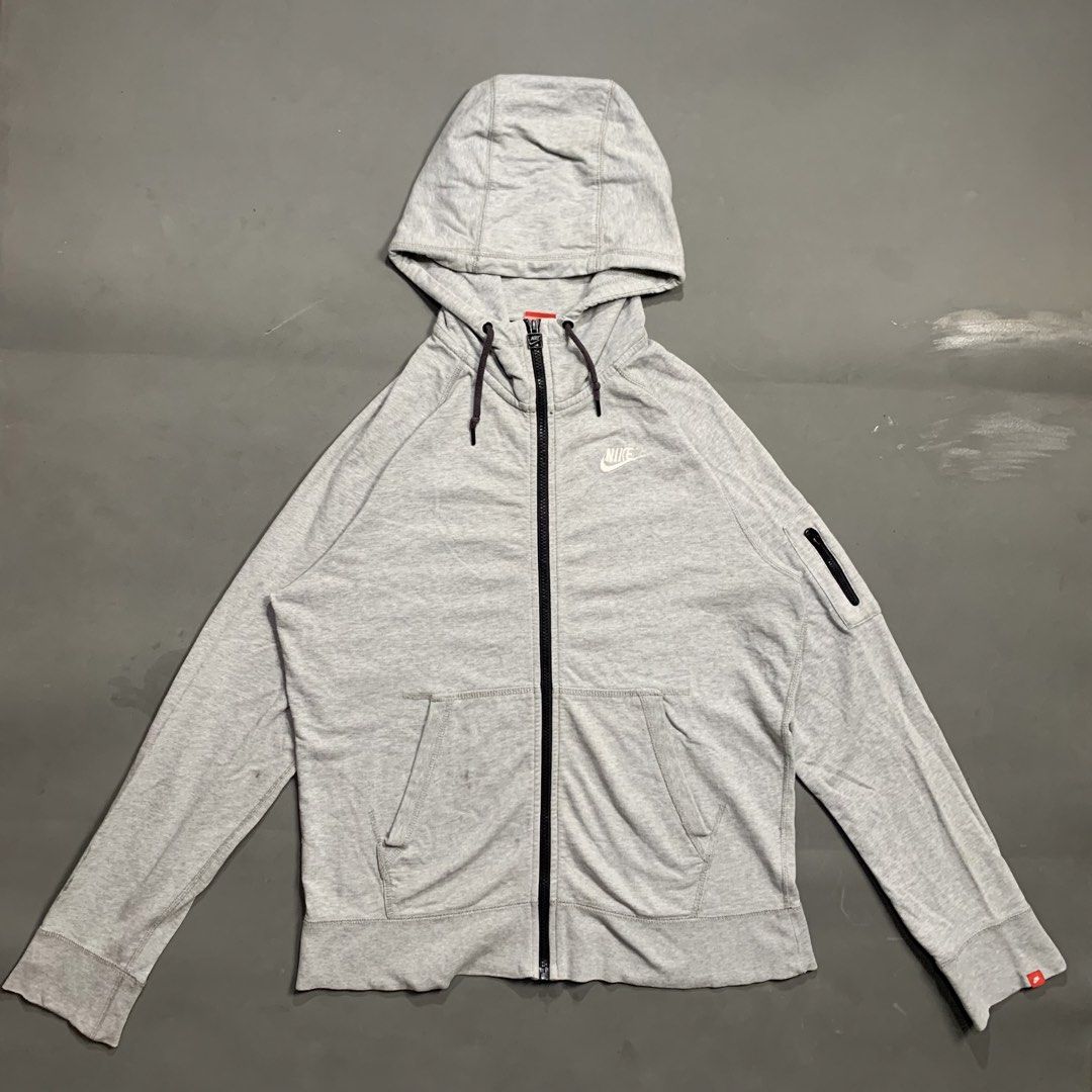 Nike Grey Zip-Up Hoodie (Category: Hoodies) located in Kalibo. Submitted by gneiss2002 (Listing ID 1469695697, Image 1). Description: - Authentic grey Nike zip-up hoodie - Material: Comfortable cotton with regular fit - Design: Full front zipper and adjustable drawstring hood - Branding: White embroidered Nike logo on the left chest - Storage: Two front pockets plus a secure zippered pocket on the left sleeve - Details: Ribbed cuffs for a snug fi
