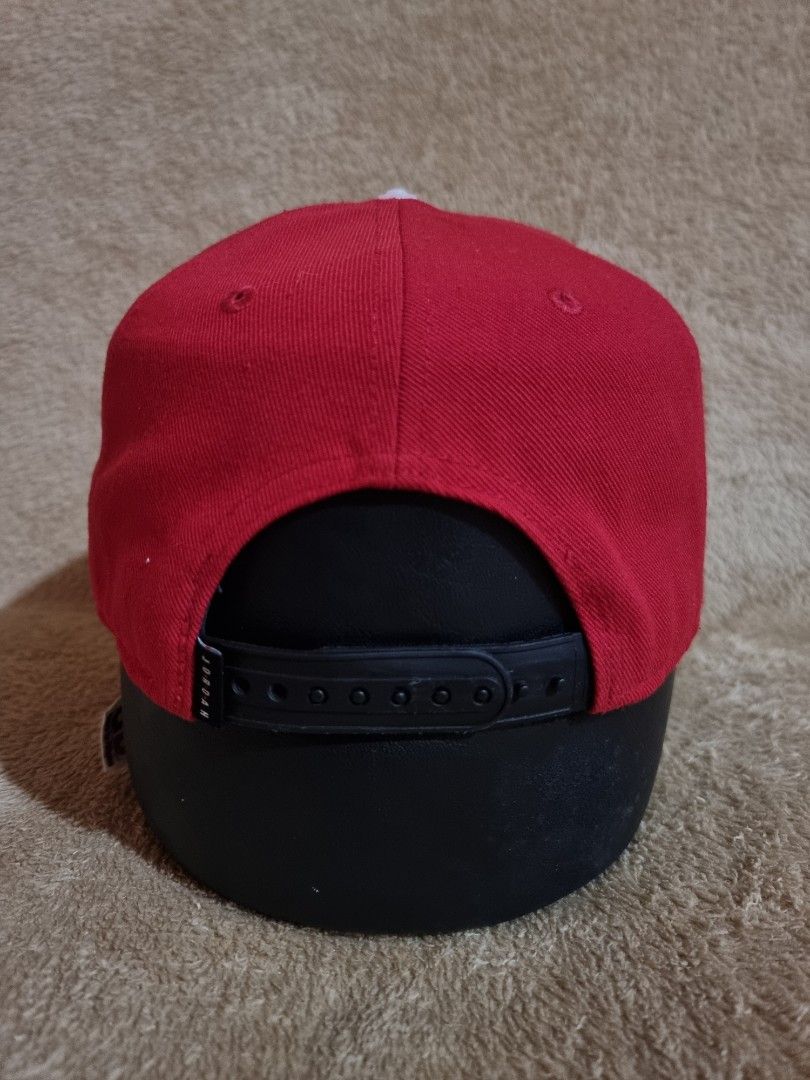 Nike Jordan Pro Jumpman Snapback Cap (Category: Caps & Hats) located in Imus. Submitted by aim_for_less (Listing ID 1469754643, Image 3). Description: Nike Jordan Pro Jumpman Snapback Cap - Brand: Jordan - Style: Classic two-tone snapback cap - Colors: Vibrant red crown with a black flat brim - Details: Iconic black embroidered Jumpman logo on the front - Fit: Adjustable snap closure at the back with small Jordan branding tab - Condition: Clean s