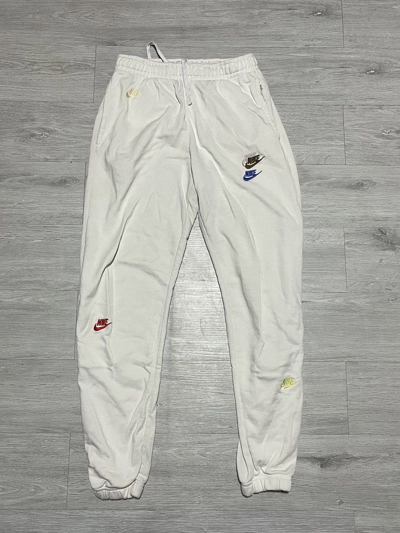 Nike Multi Logo Embroidered White Joggers Sweatpants (Category: Joggers) located in Manila. Submitted by jorgemabelin2001 (Listing ID 1469604703, Image 1). Description: - Brand/Model: White Nike Fleece Joggers - Design: Cute scattered multi-colored embroidered logos all over - Fit: Standard relaxed cut with an elastic adjustable drawstring waist - Details: Ribbed ankle cuffs for a snug fit - Material: Soft and cozy cotton blend - Condition/Use: G
