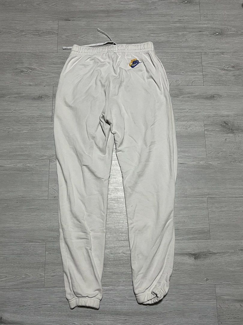Nike Multi Logo Embroidered White Joggers Sweatpants (Category: Joggers) located in Manila. Submitted by jorgemabelin2001 (Listing ID 1469604703, Image 2). Description: - Brand/Model: White Nike Fleece Joggers - Design: Cute scattered multi-colored embroidered logos all over - Fit: Standard relaxed cut with an elastic adjustable drawstring waist - Details: Ribbed ankle cuffs for a snug fit - Material: Soft and cozy cotton blend - Condition/Use: G