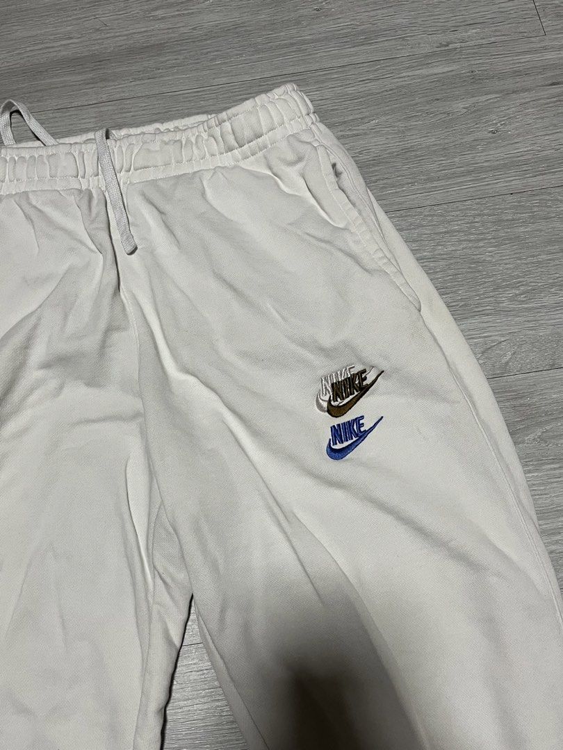 Nike Multi Logo Embroidered White Joggers Sweatpants (Category: Joggers) located in Manila. Submitted by jorgemabelin2001 (Listing ID 1469604703, Image 3). Description: - Brand/Model: White Nike Fleece Joggers - Design: Cute scattered multi-colored embroidered logos all over - Fit: Standard relaxed cut with an elastic adjustable drawstring waist - Details: Ribbed ankle cuffs for a snug fit - Material: Soft and cozy cotton blend - Condition/Use: G