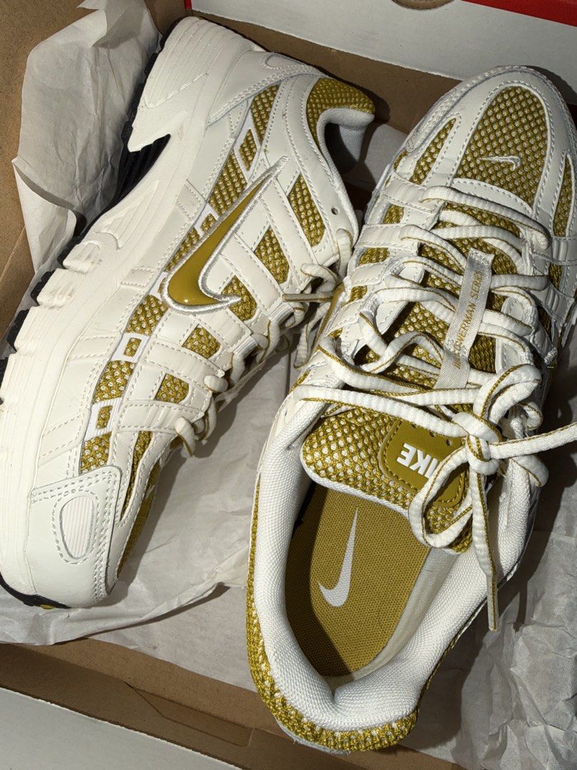 Nike P-6000 White Metallic Gold Sneakers (Category: Shoe inserts & accessories) located in Manila. Submitted by rosellegrey25 (Listing ID 1469716407, Image 3). Description: - Model: Nike P-6000 - Colorway: White and Metallic Gold - Design: Mesh and leather overlays with retro running aesthetics - Special Detail: Bowerman Series tongue pull tab Size 8.5 US - Inclusion: Complete with original shoebox - Condition: Brand new / Excellent (ready to wea