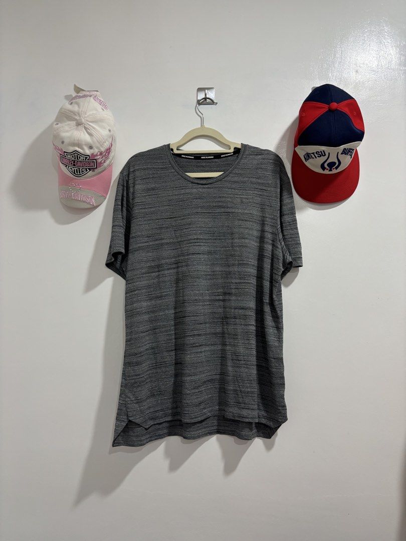 Nike Running Gray Heather Athletic T-Shirt (Category: Activewear) located in Calbayog City. Submitted by zaxcheus_castillo1708 (Listing ID 1469672427, Image 1). Description: - Brand: Nike - Color: Gray Heather (marled texture) - Style: Crew neck with branded inner taping, short sleeves - Fit: Curved hem at the back for extra workout coverage - Material: Lightweight, breathable athletic fabric - Condition: Excellent, ready to wear.
