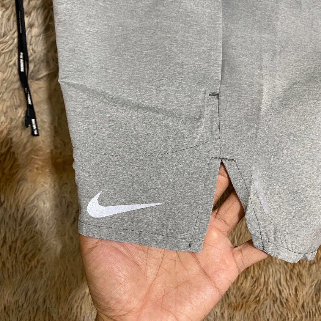 Nike Running Shorts Grey with Drawstring (Category: Shorts) located in Butuan. Submitted by jc13thrifts (Listing ID 1469752385, Image 3). Description: - Authentic grey Nike running shorts - Lightweight, breathable material - Elastic waistband with black Nike Running branded drawstring - Reflective swoosh logo on lower leg for visibility - Slit hems for maximum mobility - Secure back zippered pocket on the right hip - Clean condition, great for wo