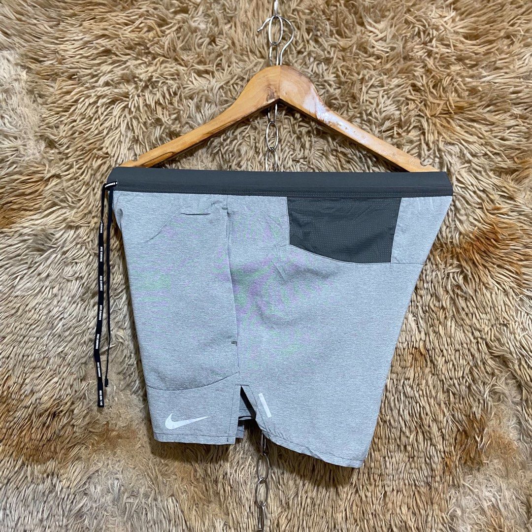 Nike Running Shorts Grey with Drawstring (Category: Shorts) located in Butuan. Submitted by jc13thrifts (Listing ID 1469752385, Image 2). Description: - Authentic grey Nike running shorts - Lightweight, breathable material - Elastic waistband with black Nike Running branded drawstring - Reflective swoosh logo on lower leg for visibility - Slit hems for maximum mobility - Secure back zippered pocket on the right hip - Clean condition, great for wo