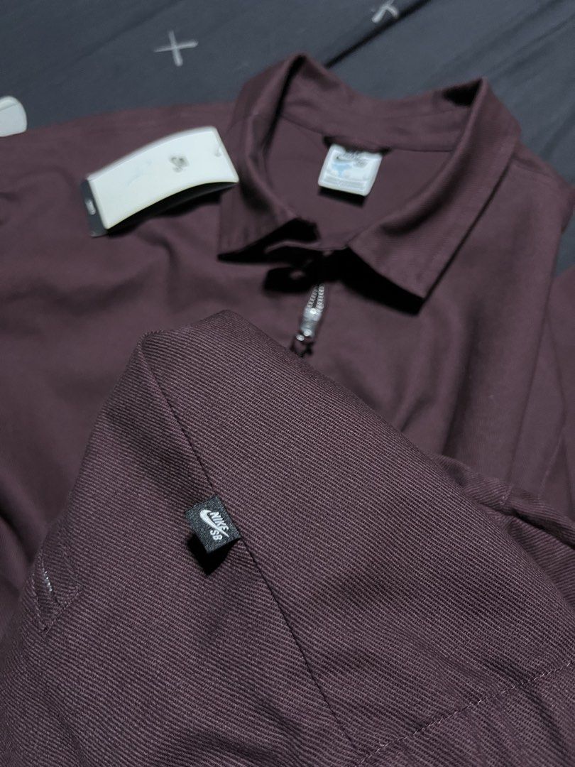 Nike SB Full-Zip Canvas Jacket Maroon Size M (Category: Coats, Jackets and Outerwear) located in Manila. Submitted by modestostephen_ (Listing ID 1469689255, Image 3). Description: - Brand: Nike SB - Item: Full-Zip Canvas Jacket - Color: Dark Maroon - Size: Medium (Loose Fit Silhouette) - Features: Collared neckline, zippered side pockets, elastic cuffs and hem - Condition: Brand new with tags (BNWT), extra button attached inside.